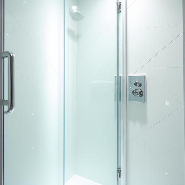 Gleaming bathroom shower glass and polished fixtures